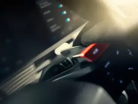 A close up of a person holding a steering wheel in a car. Ioniq 5