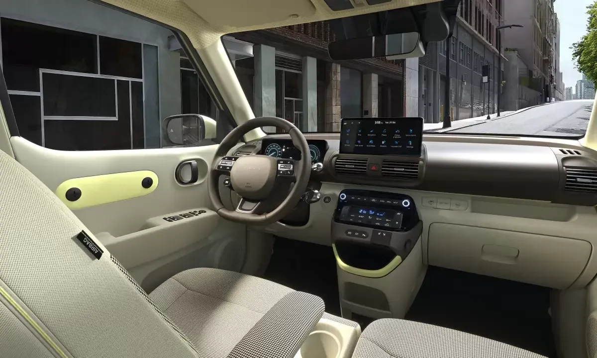 The interior of a car with a steering wheel and a dashboard. Inster