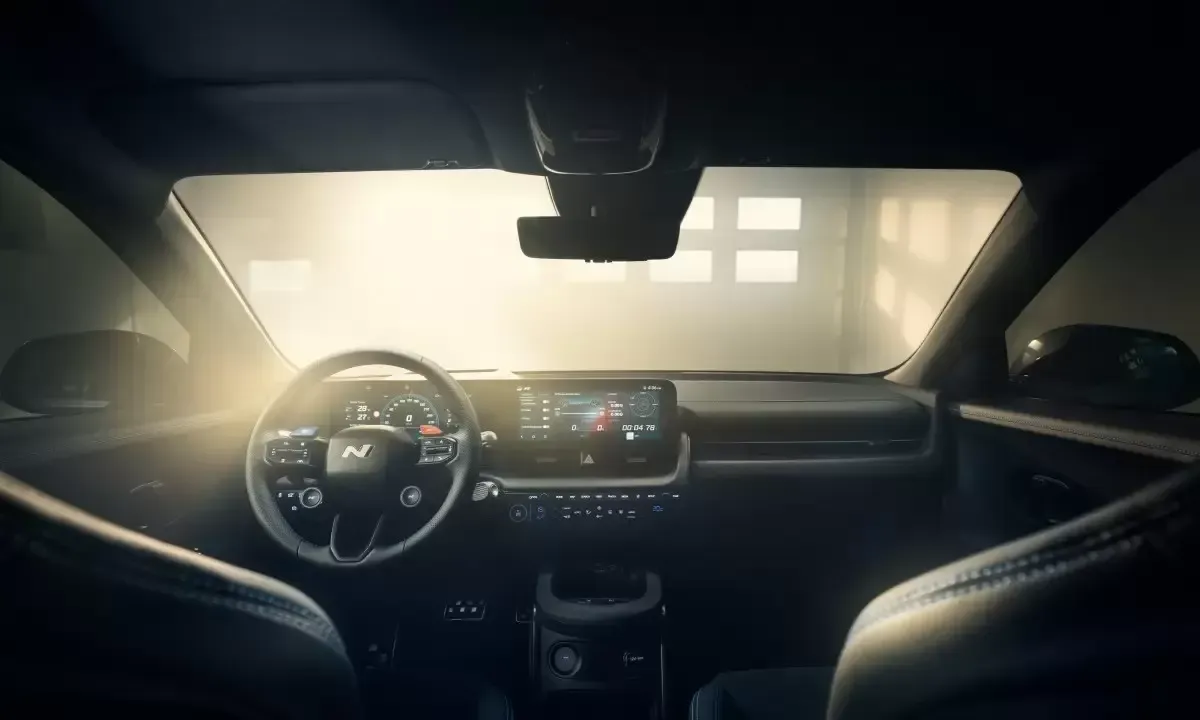 The inside of a car with the sun shining through the windshield. Ioniq 5 N