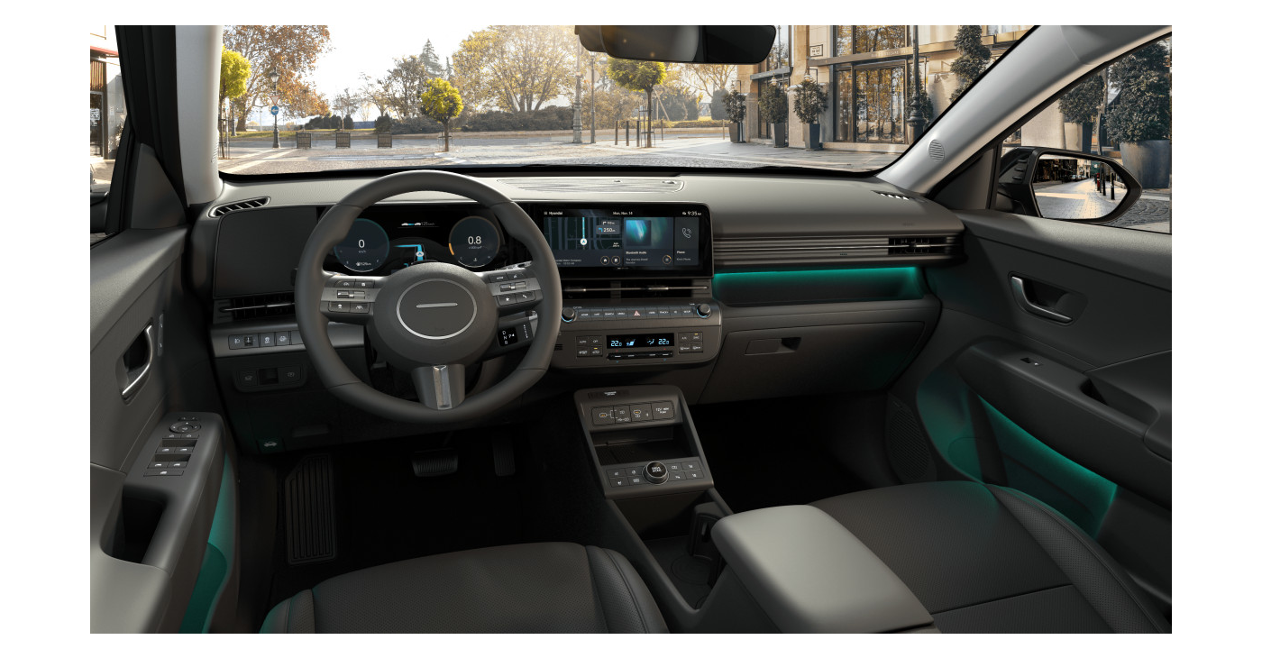 The interior of a car with a steering wheel and a dashboard. Kona