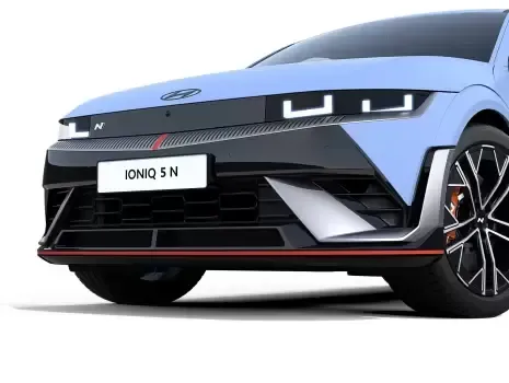A blue and black hyundai ioniq 5 n is parked on a white background.