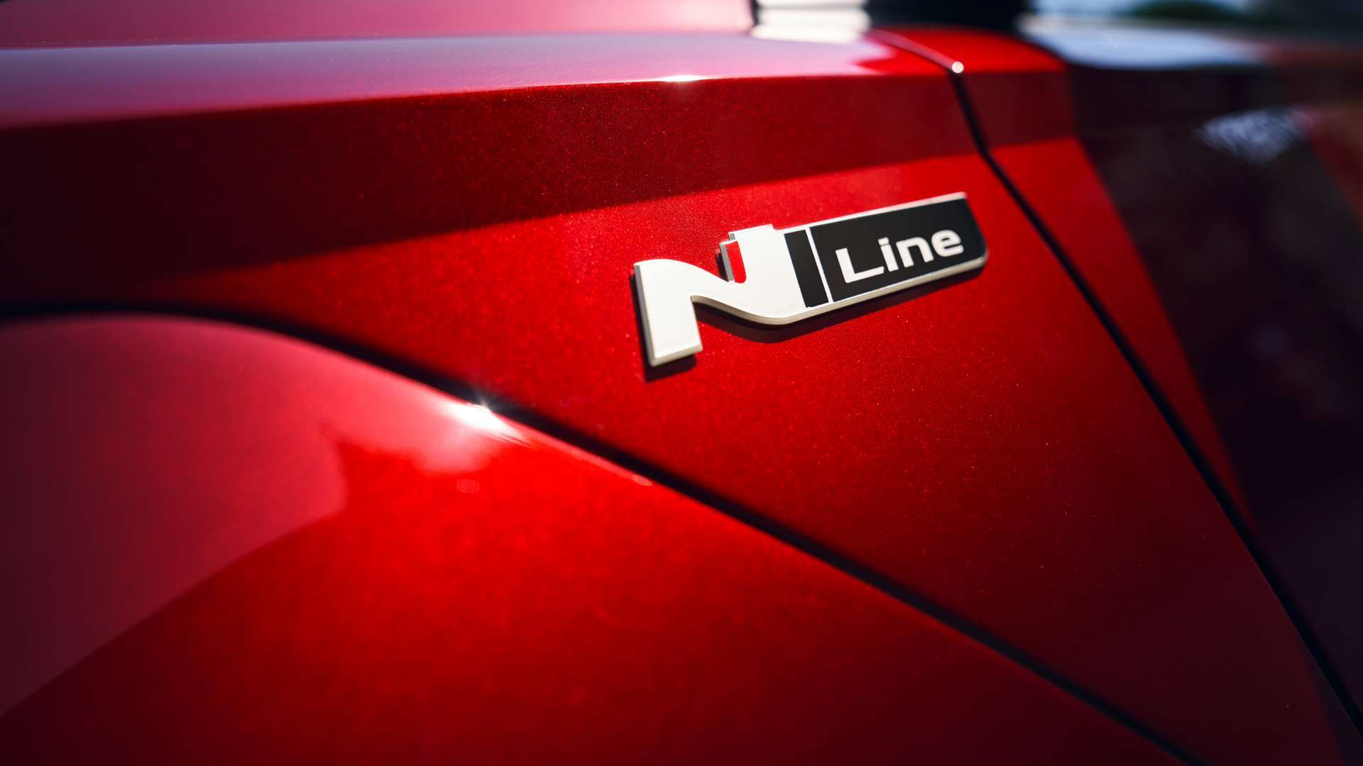 A red car with a n line emblem on the side