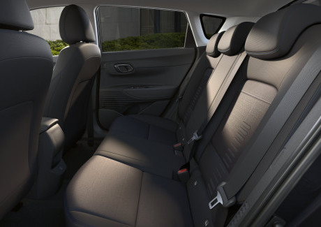 The back seat of a car with a seat belt. Bayon
