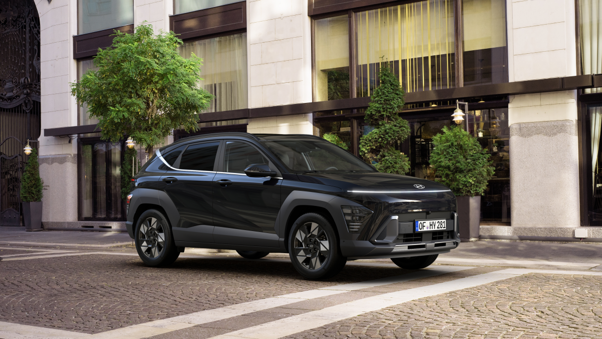 A black suv is parked in front of a building. Kona