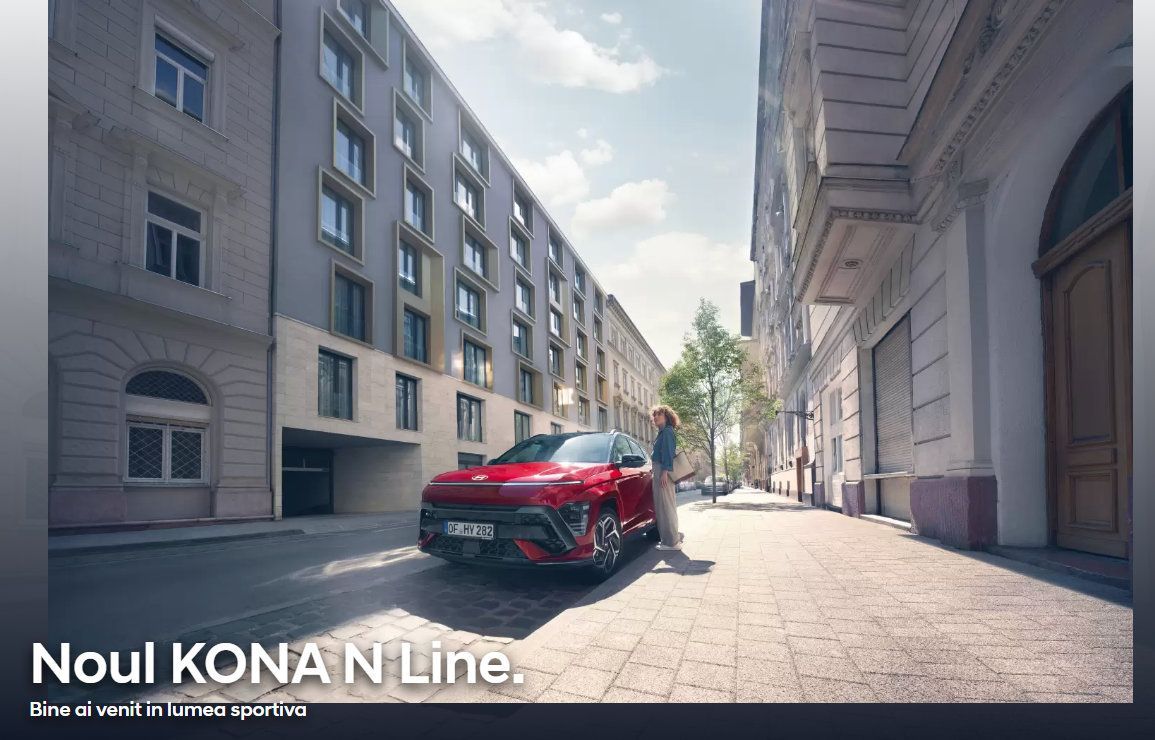 A red car is parked in the middle of a city street. Kona N Line