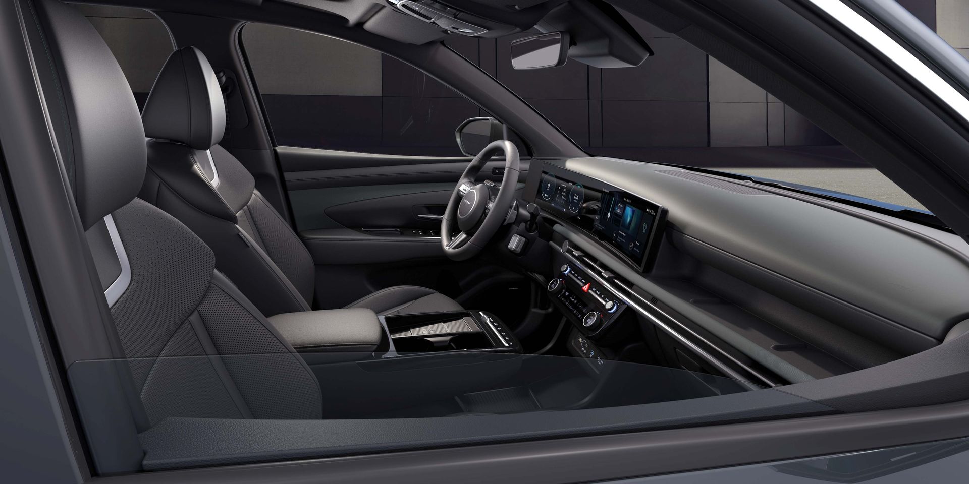 The interior of a car with a steering wheel and dashboard. tucson 