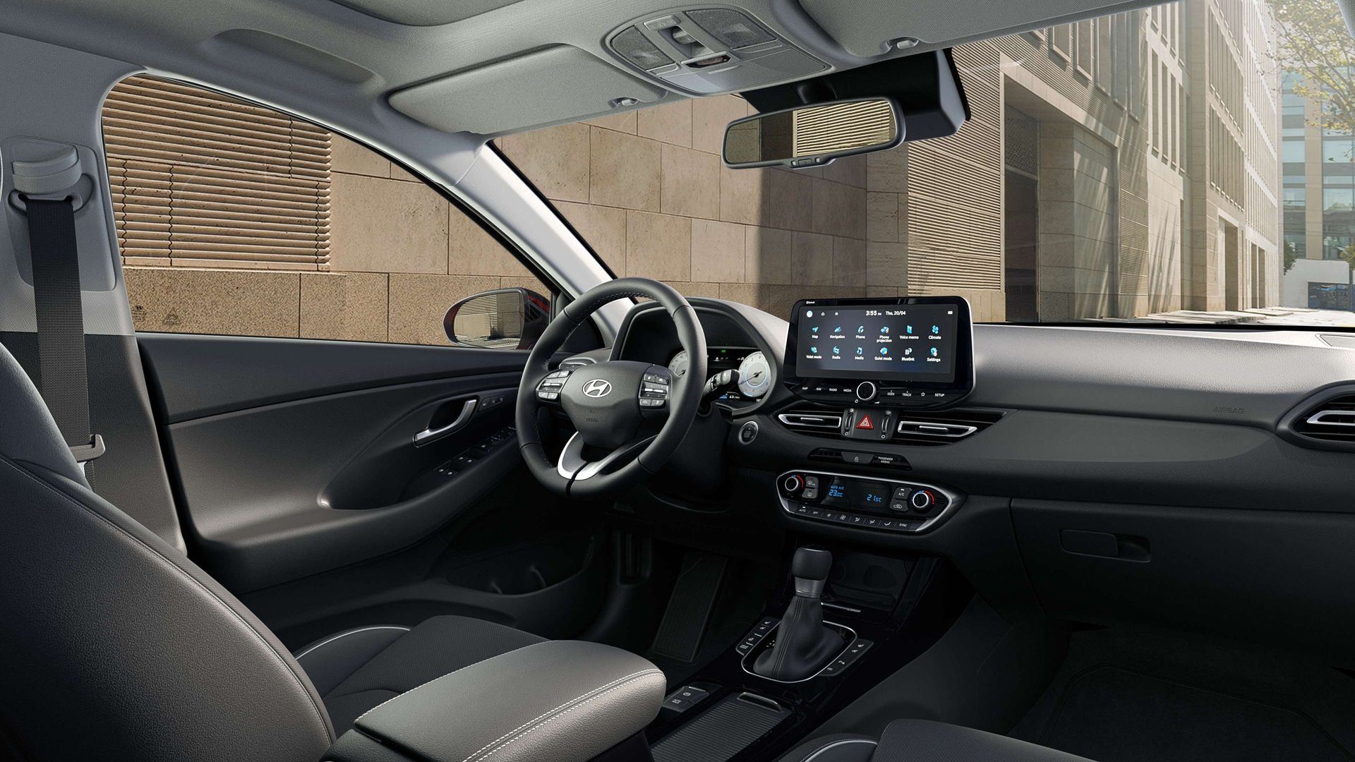 The interior of a car with a steering wheel and a dashboard.