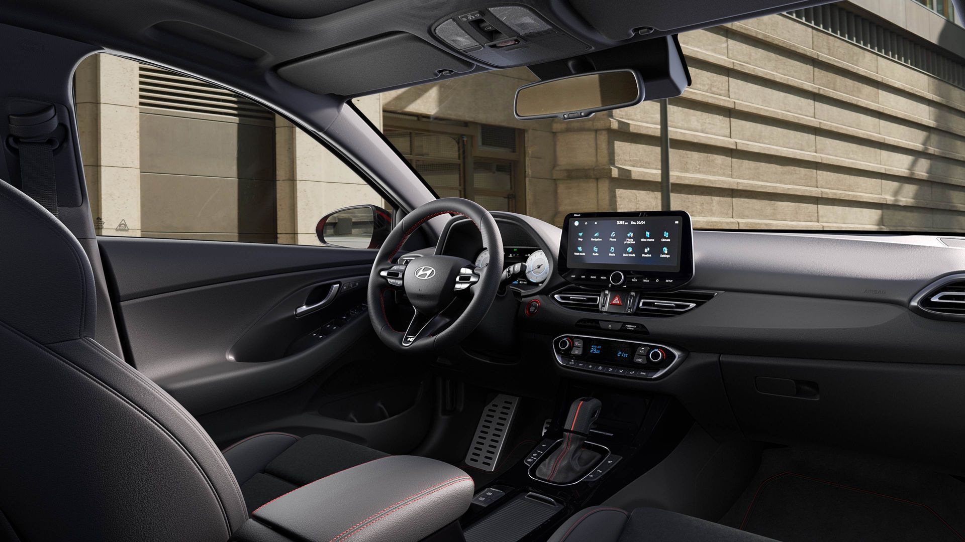 The interior of a car with a steering wheel and a dashboard.