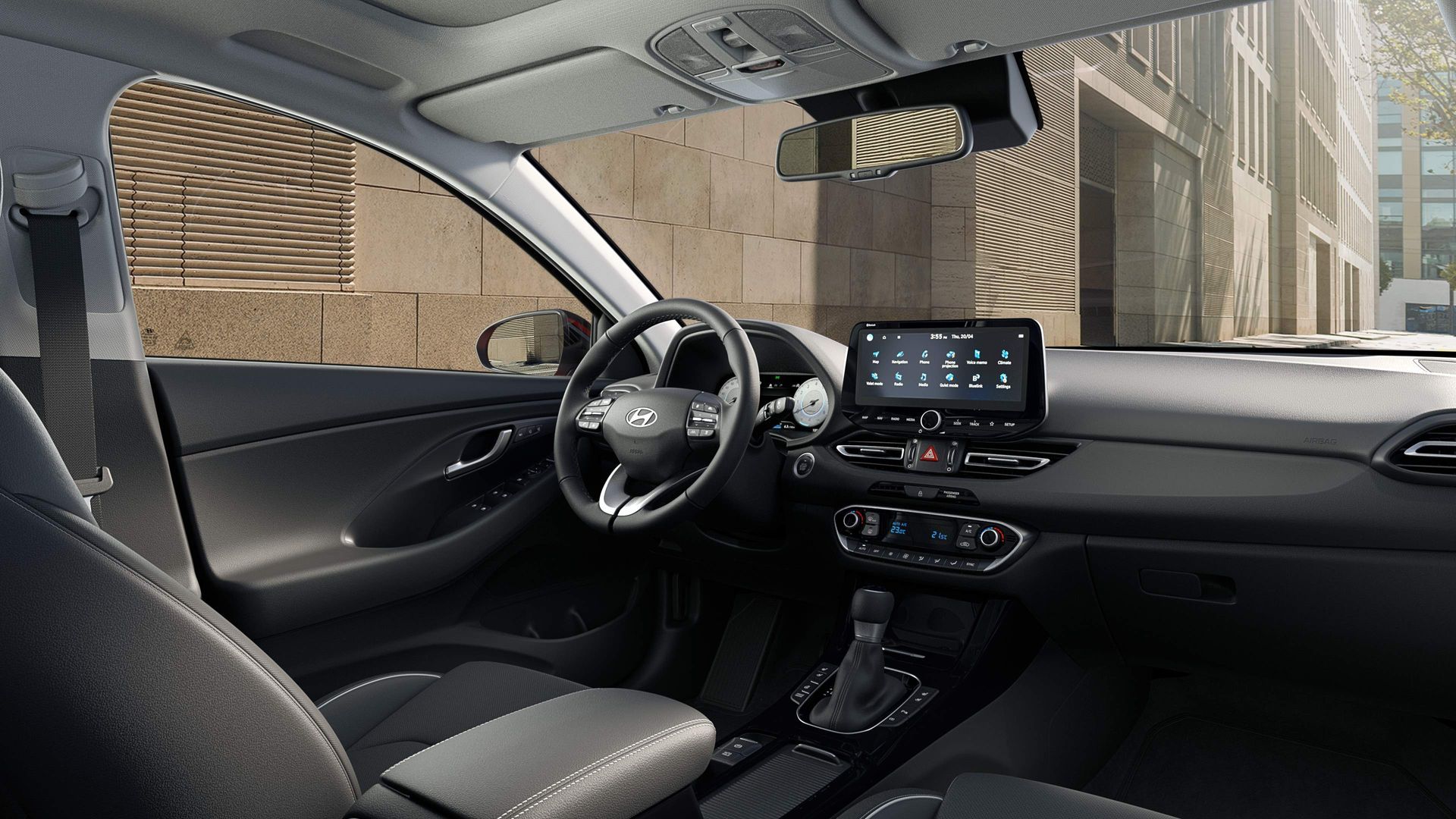 The interior of a car with a steering wheel and a dashboard.