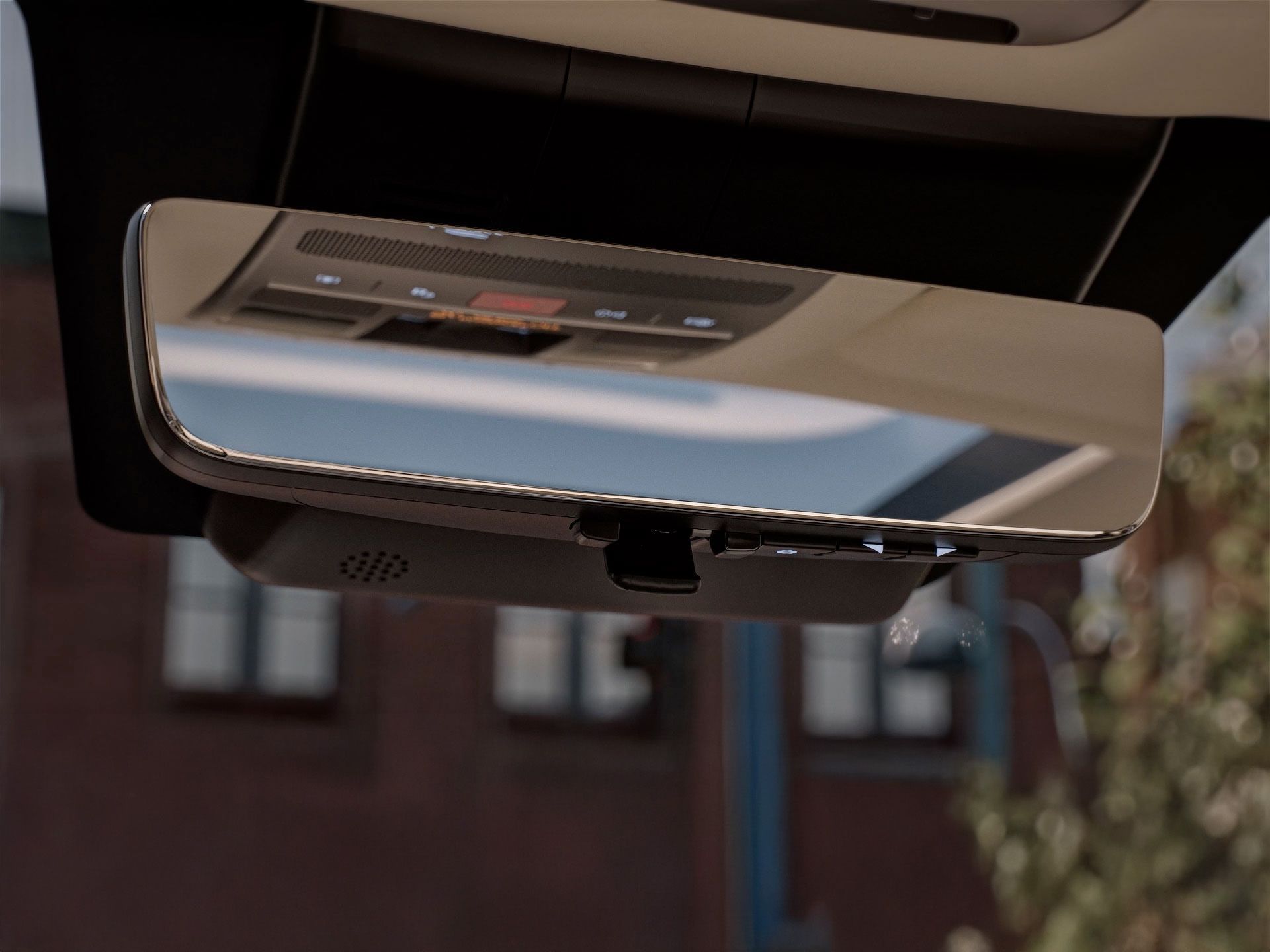 A person is looking at the rear view mirror of a car. Santa Fe