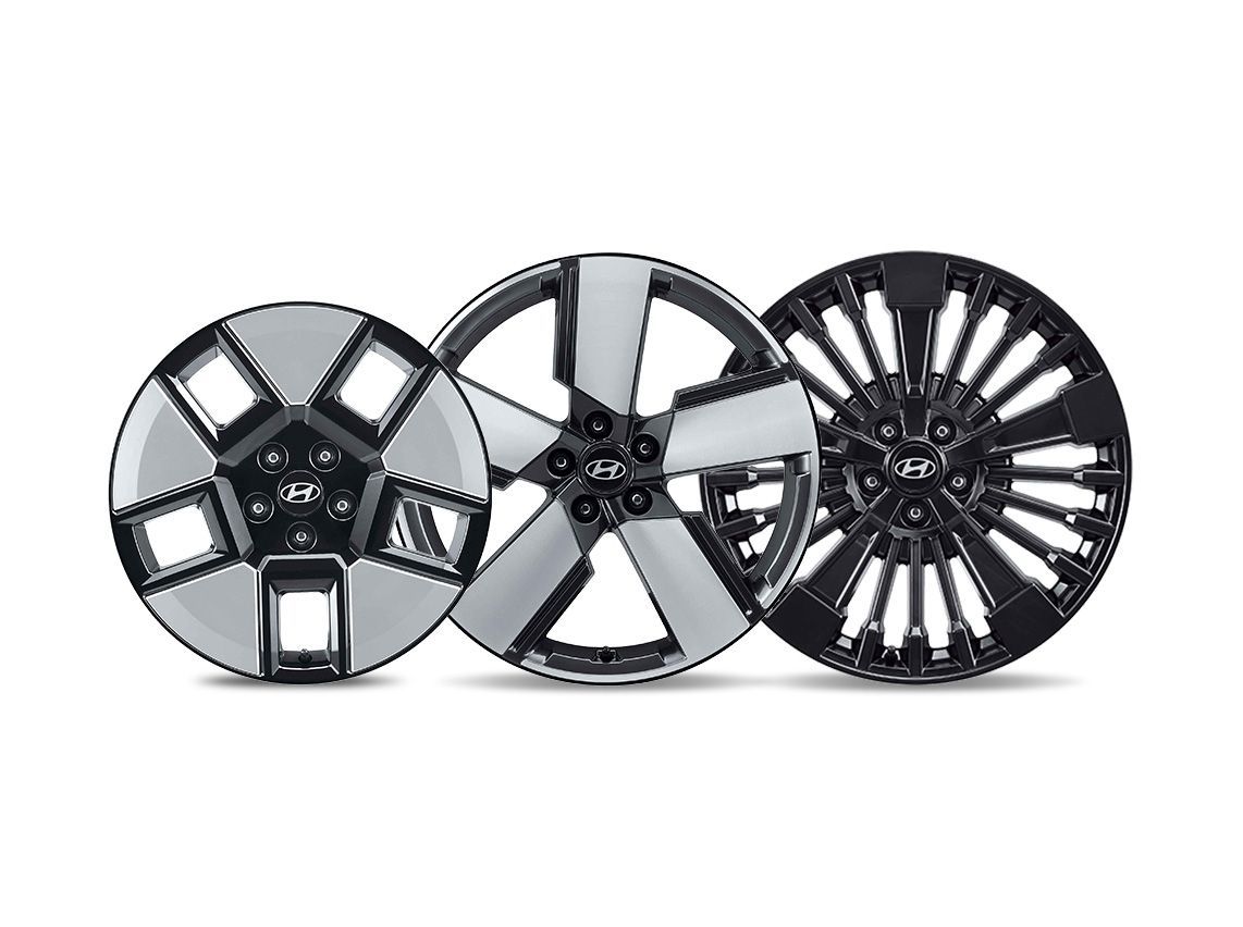 Three different types of wheels are sitting next to each other on a white background.