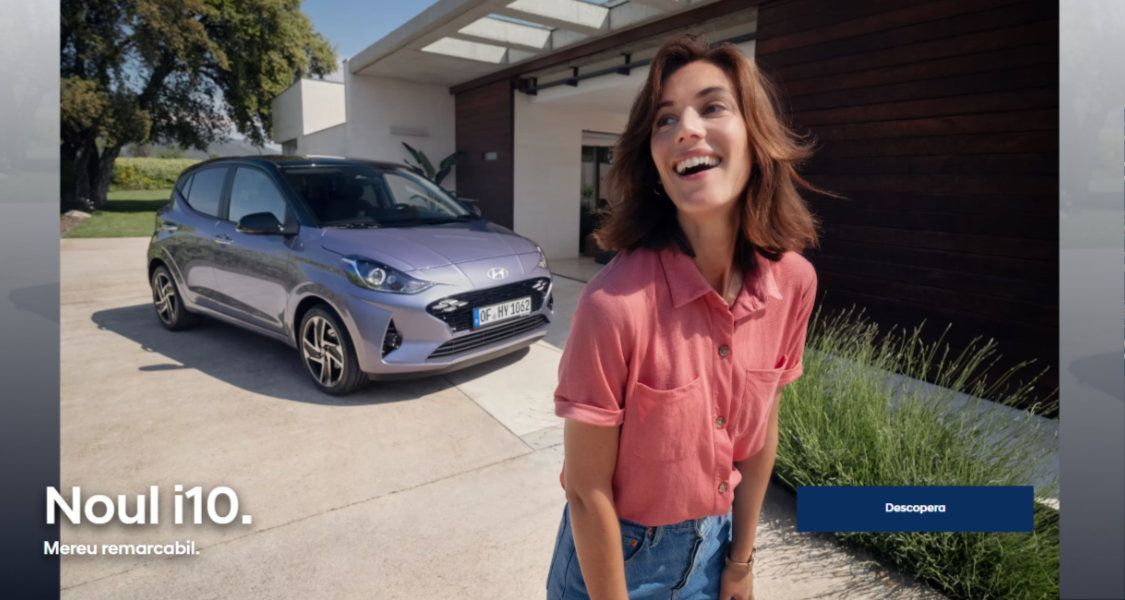 A woman is standing in front of a purple car. i10