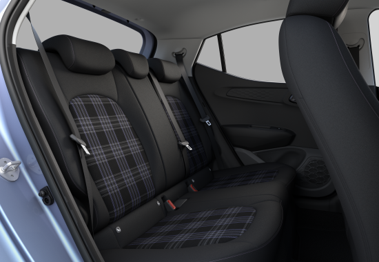 The back seat of a blue car with plaid seat covers i10