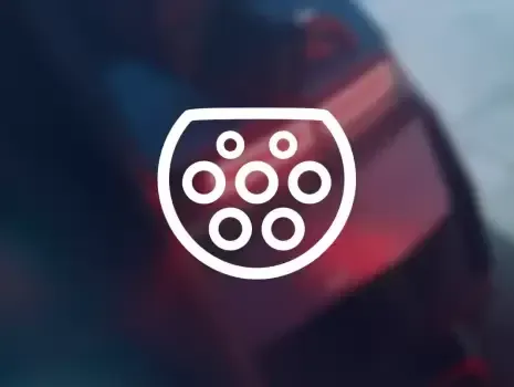 A close up of a charging port on the back of a car.