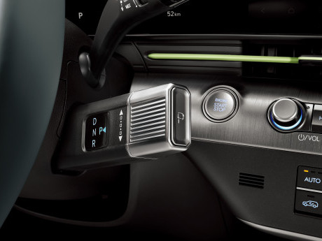 A close up of the steering wheel and dashboard of a car. Kona