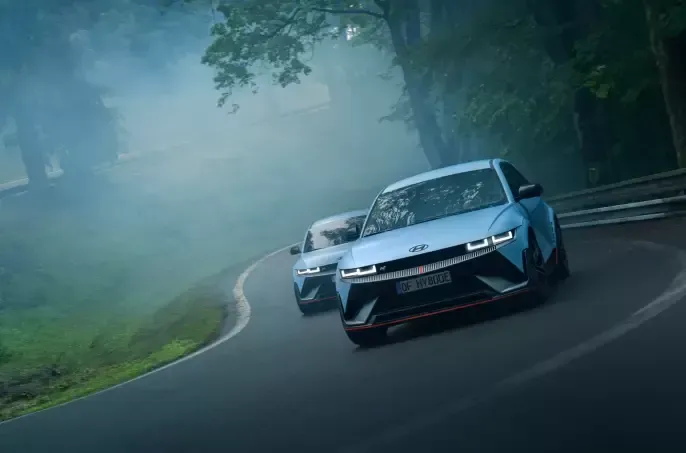 Two cars are driving down a foggy road. Ioniq 5 N