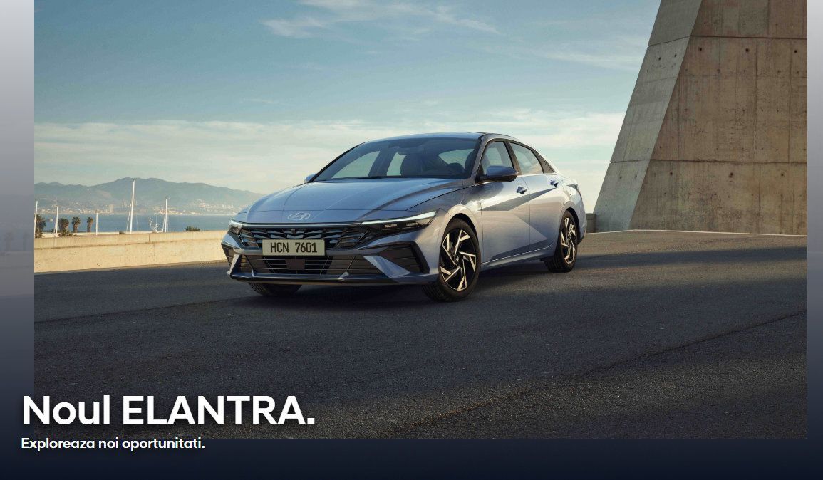 A silver hyundai elantra is parked on the side of the road. E;antra