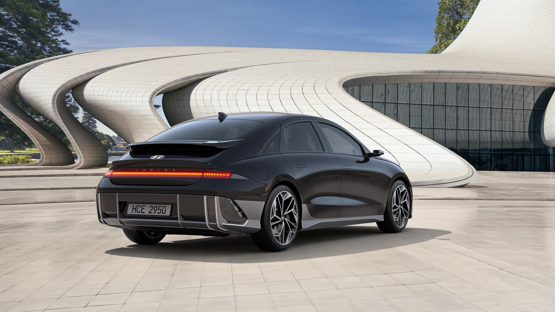 A black car is parked in front of a building. Ioniq 6