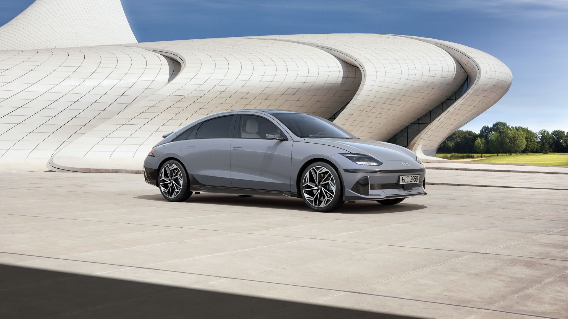 A gray car is parked in front of a building. Ioniq 6