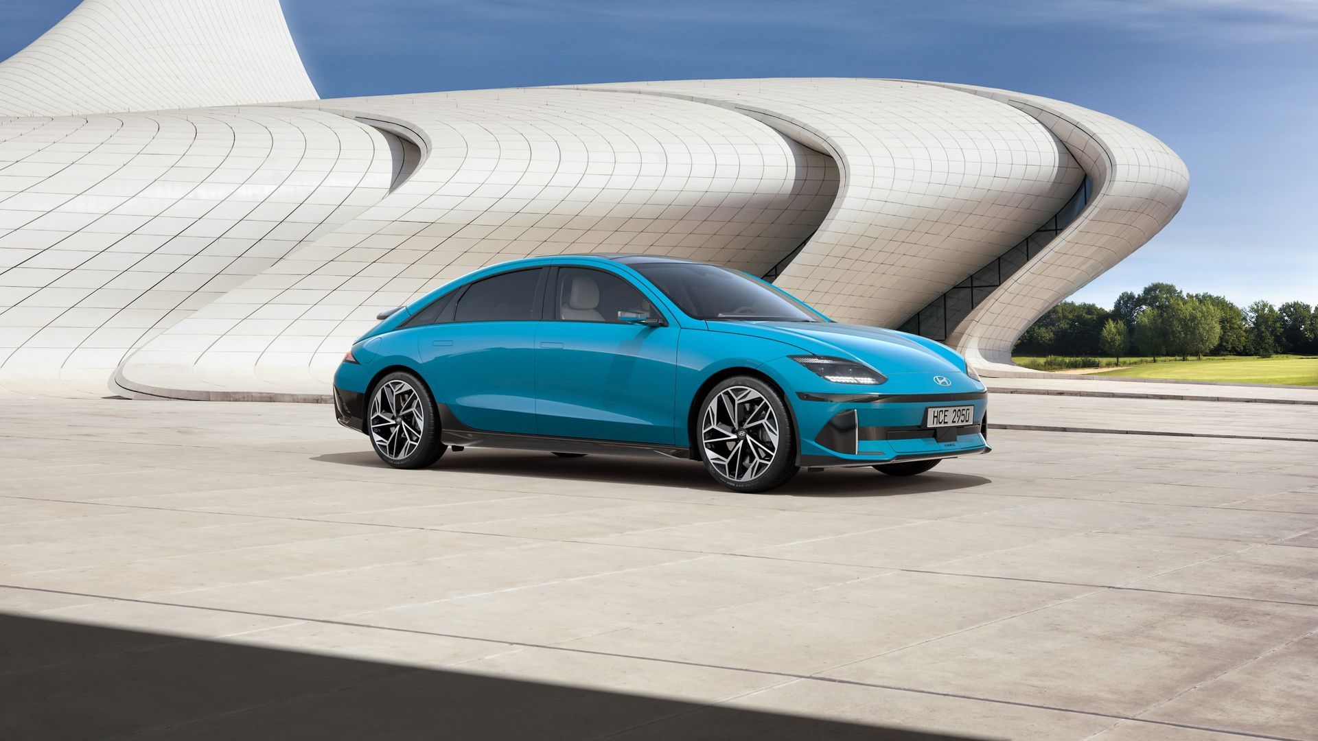 A blue car is parked in front of a building. Ioniq 6