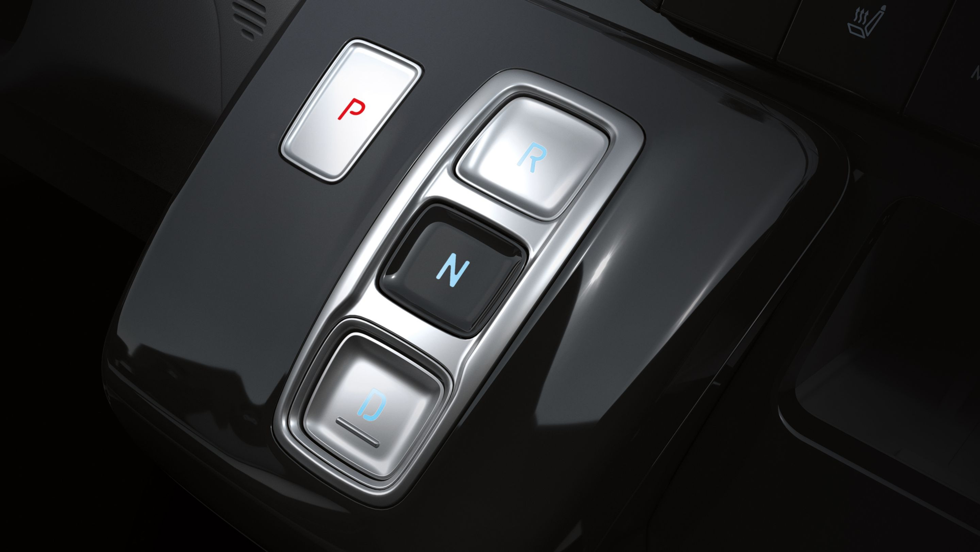A close up of a shifter in a car with a p and n button. Staria