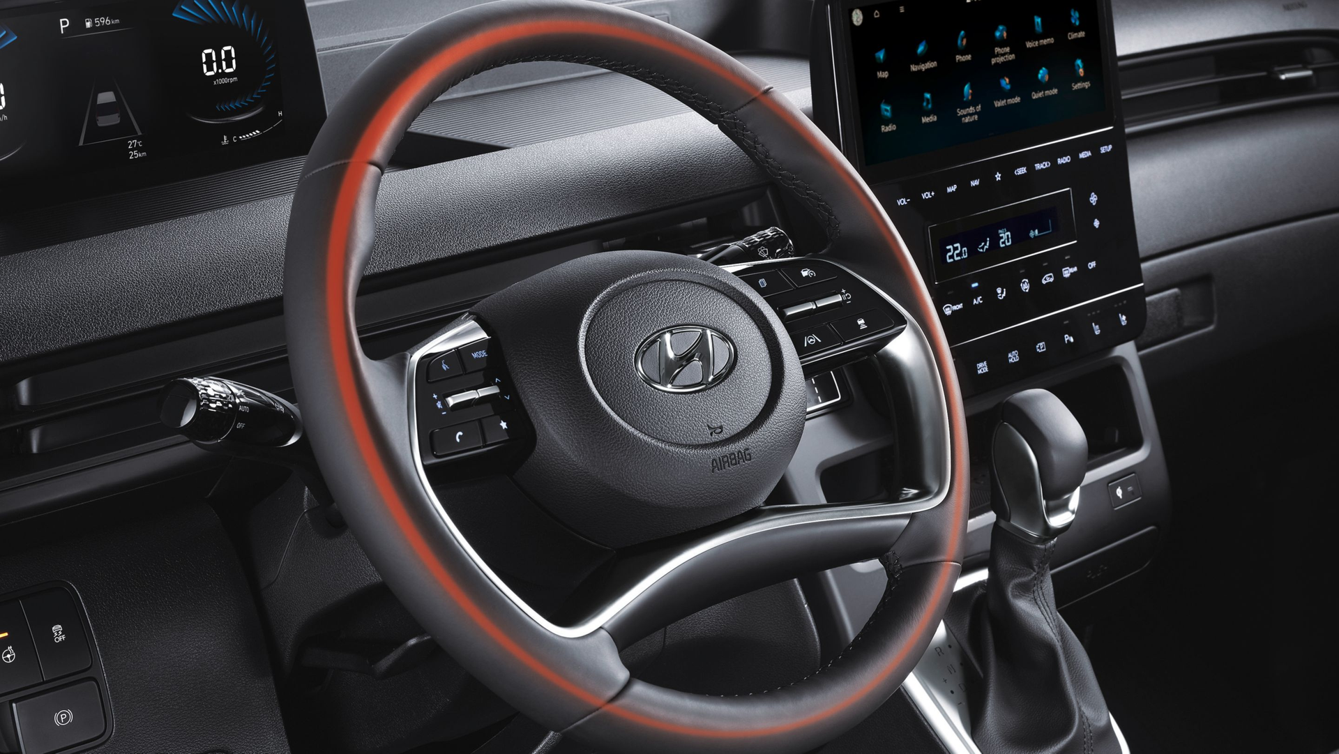 A close up of a steering wheel in a car Staria