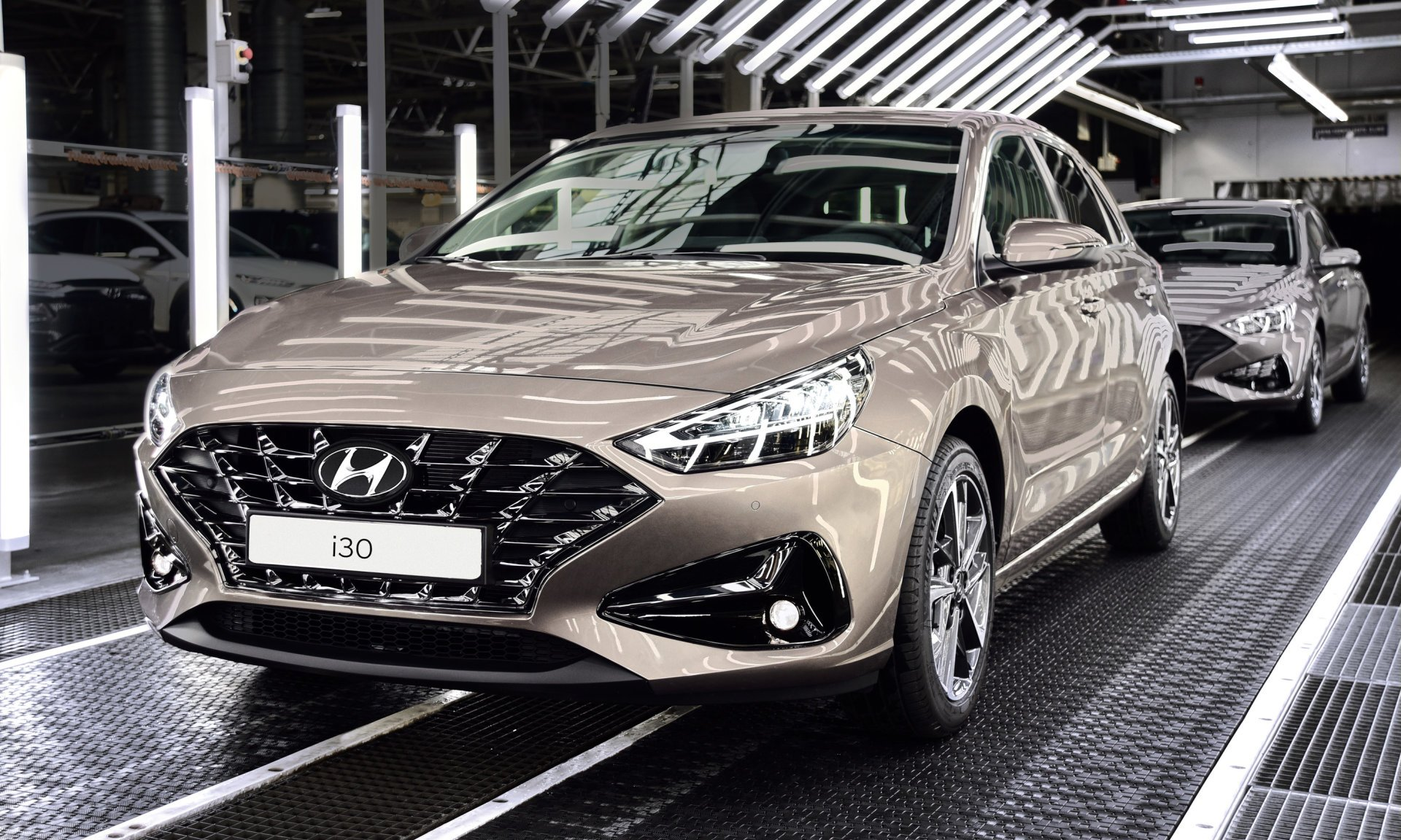 A hyundai i30 is being built in a factory. i30