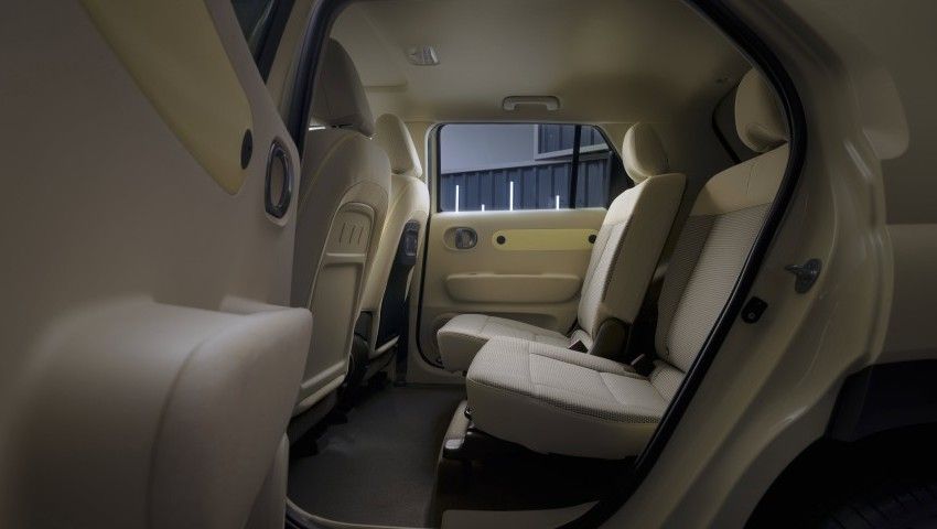 The back seat of a white car with the door open. Inster