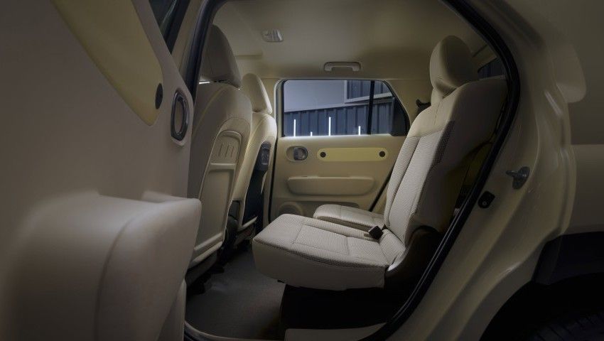 The back seat of a white car with the door open. Inster