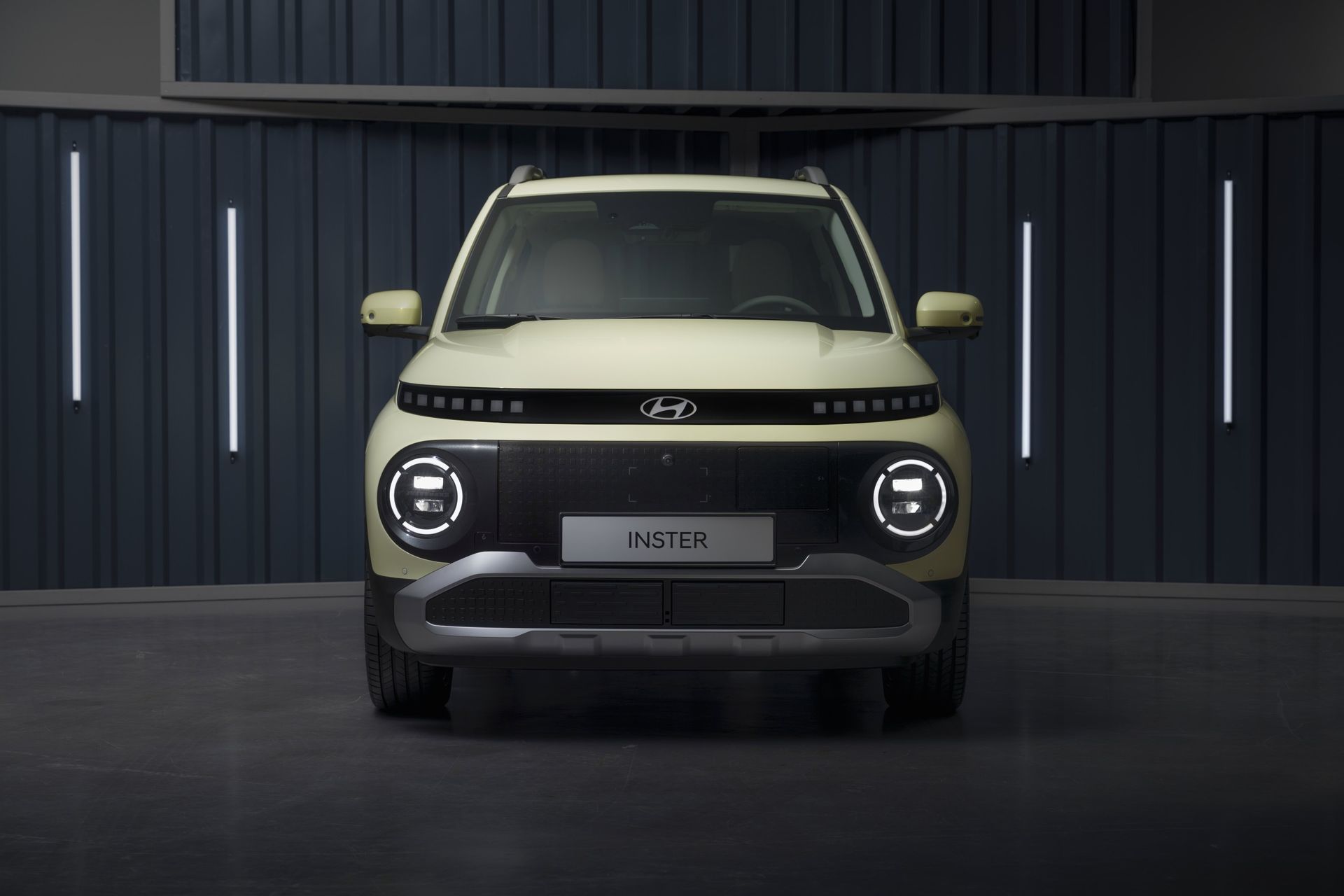A yellow car is parked in front of a garage door. Inster