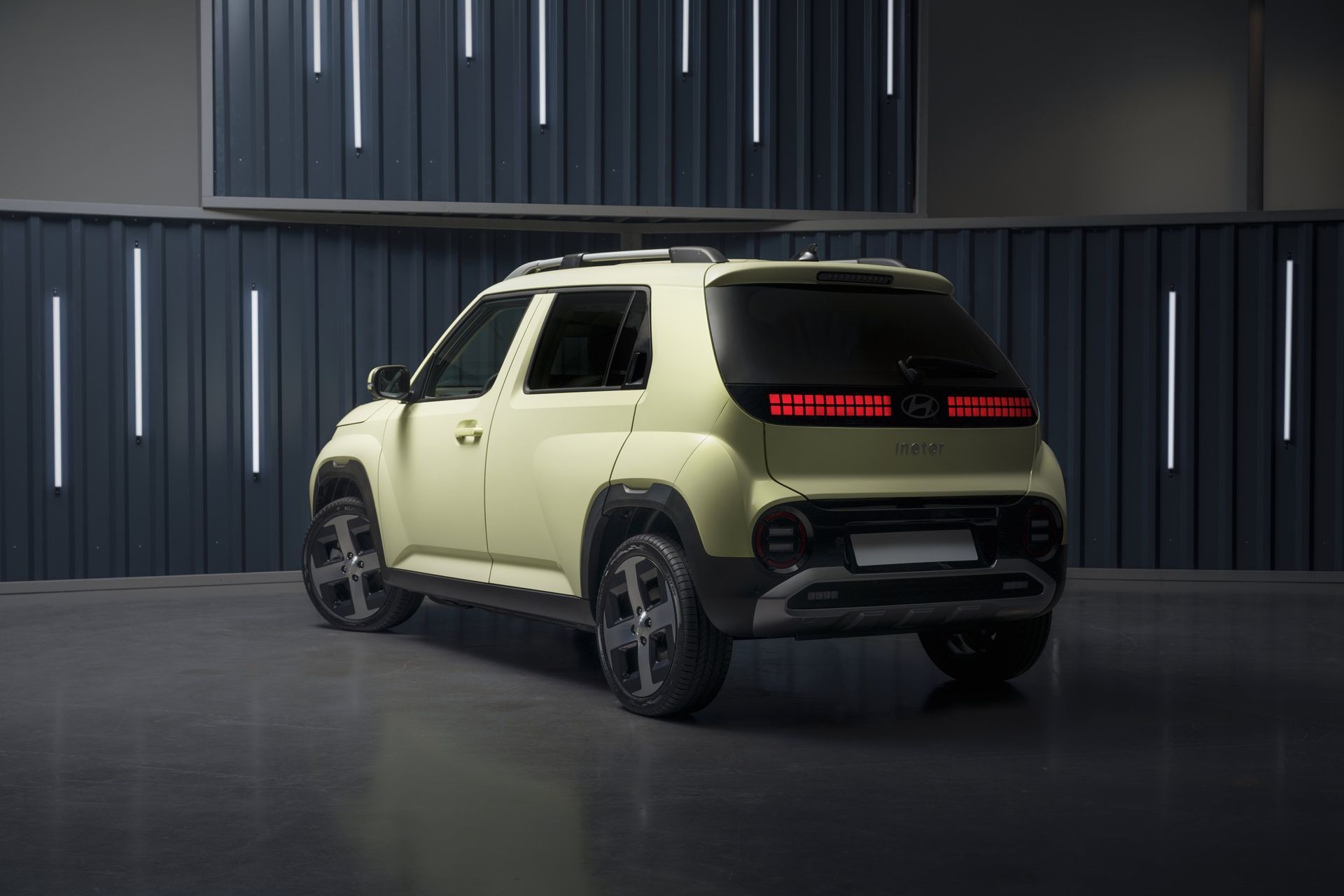 A yellow suv is parked in a garage next to a wall. Inster
