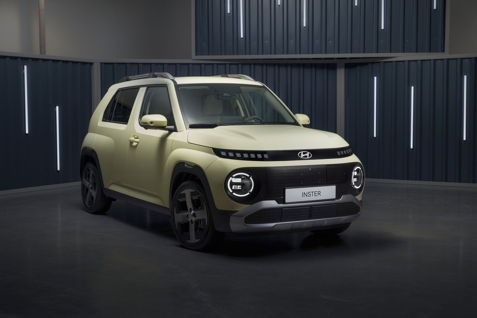A yellow and black car is parked in a garage. Inster