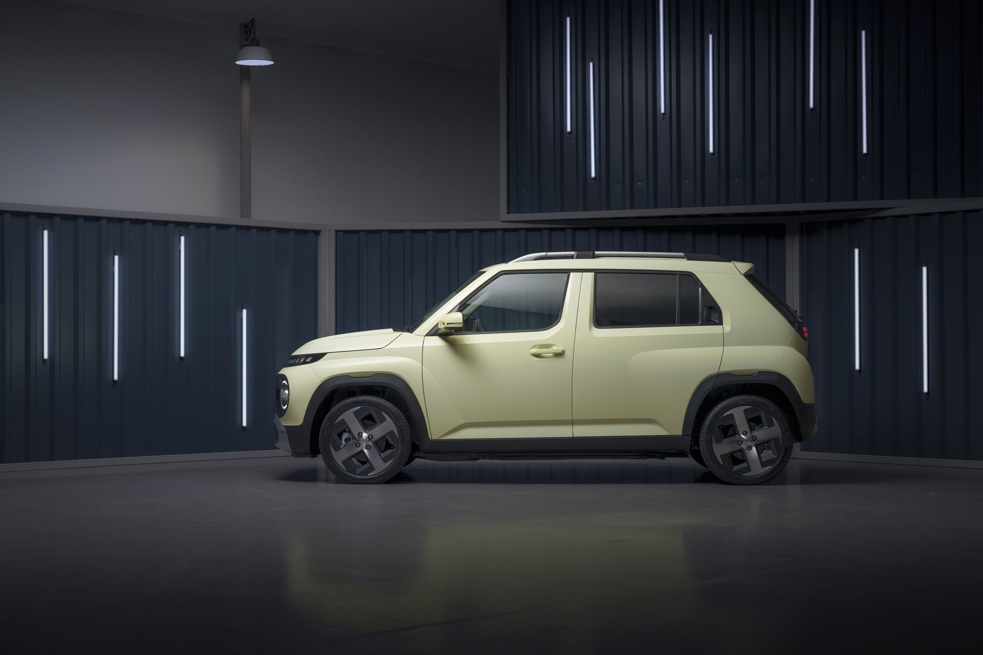 A yellow car is parked in a garage next to a wall. Inster