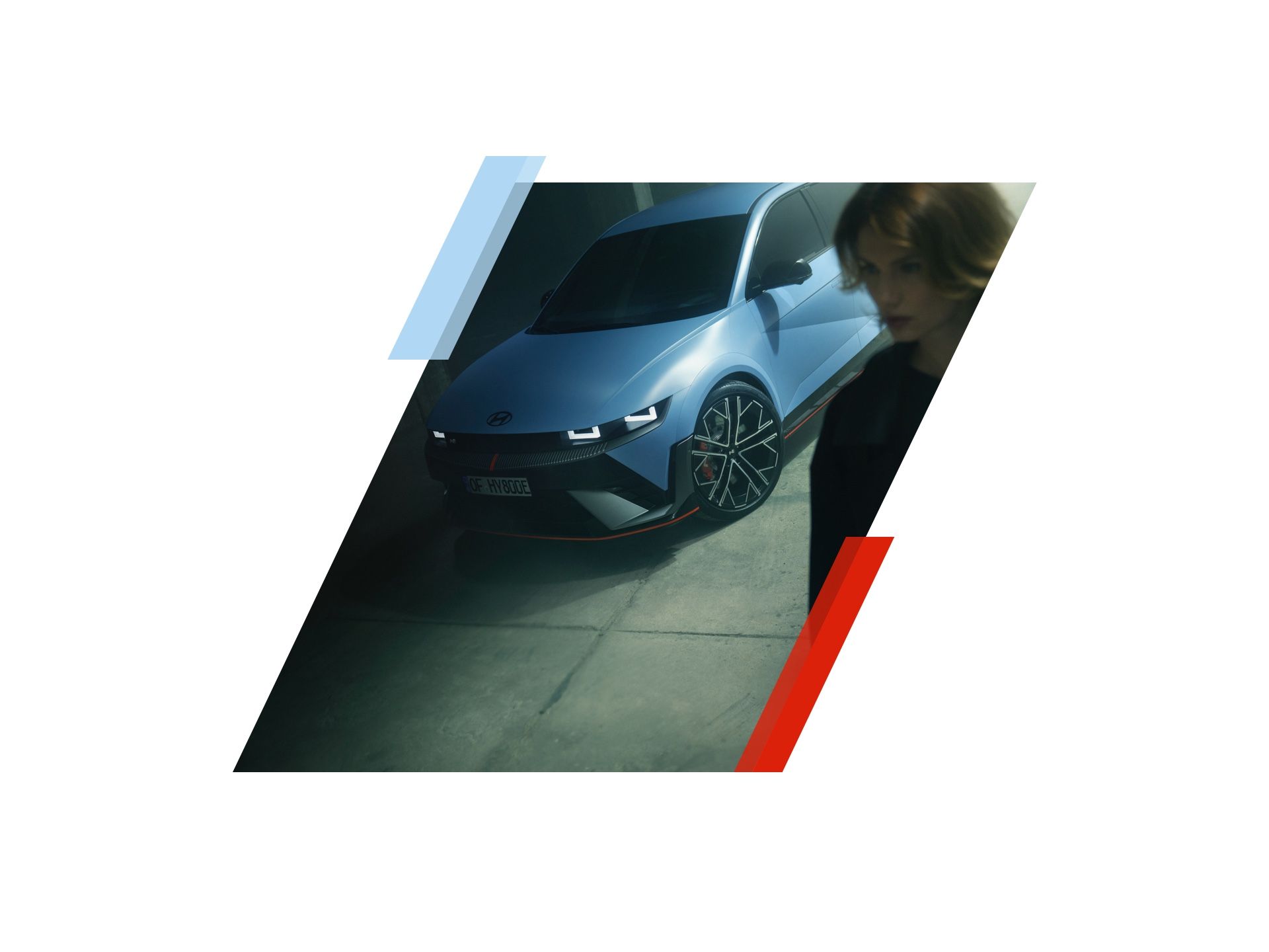 A woman is standing in front of a blue car. Ioniq 5 N