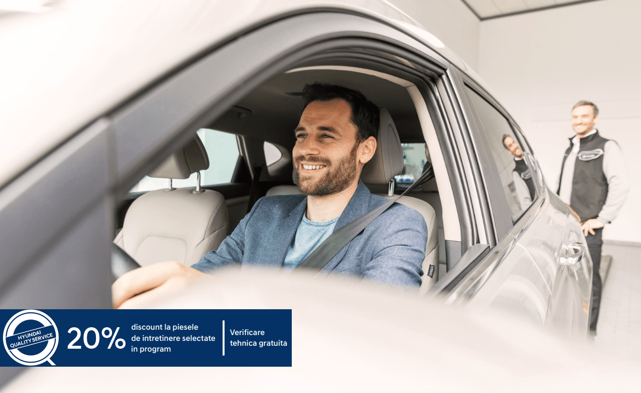 A man is sitting in the driver 's seat of a car.