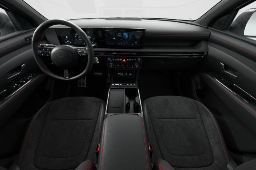 The interior of a car with black seats and a steering wheel.