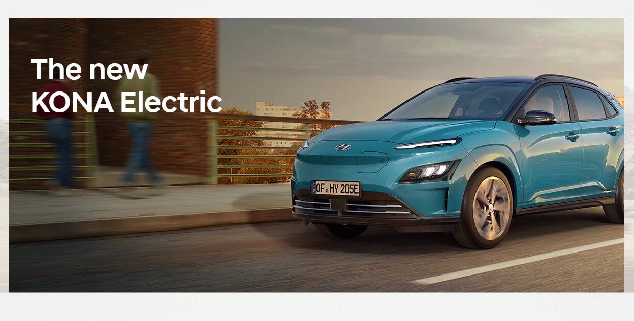 A blue electric car is parked on the side of the road.