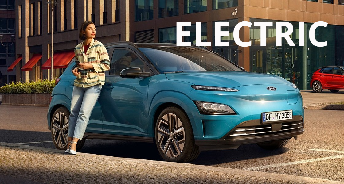 A woman is leaning against a blue electric car.