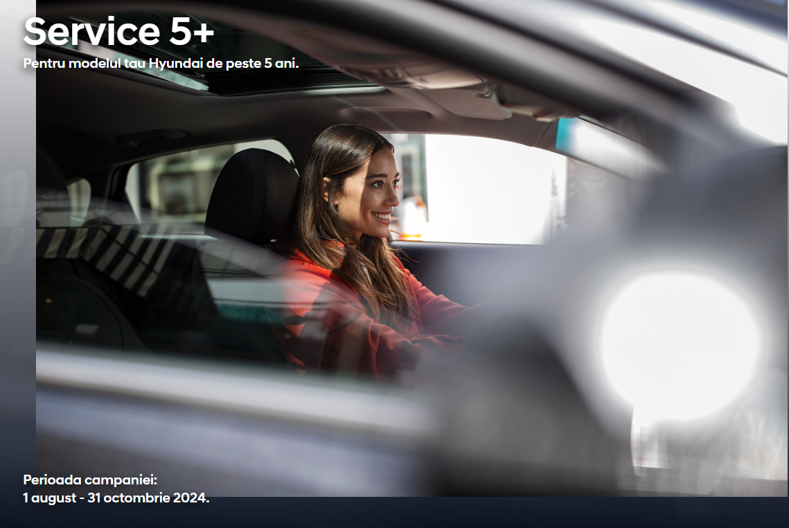 A woman is sitting in the driver 's seat of a car.