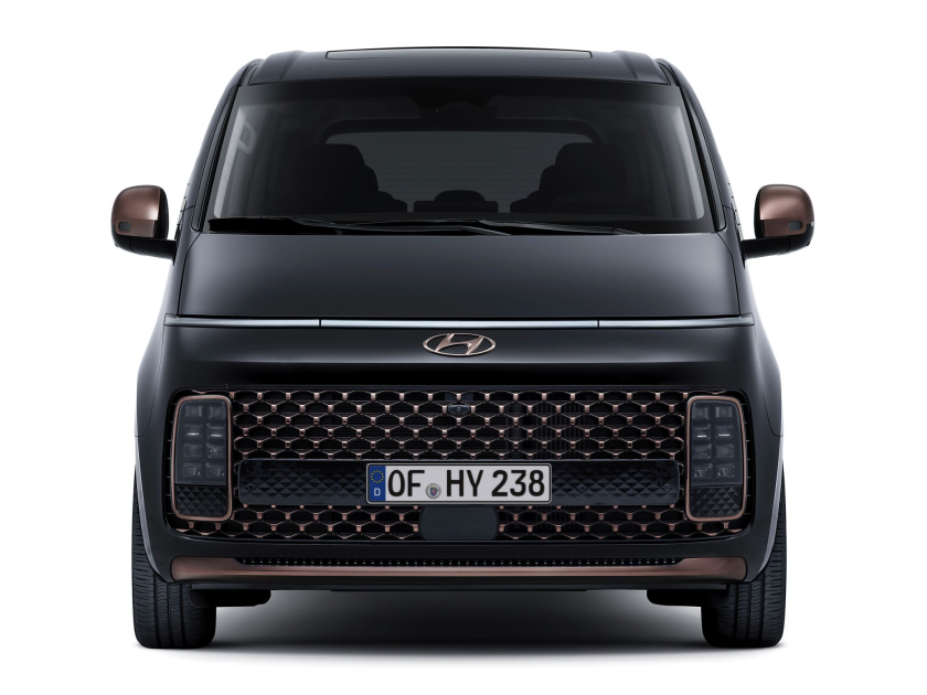 The front of a black van with a license plate that says of hy 238. Staria