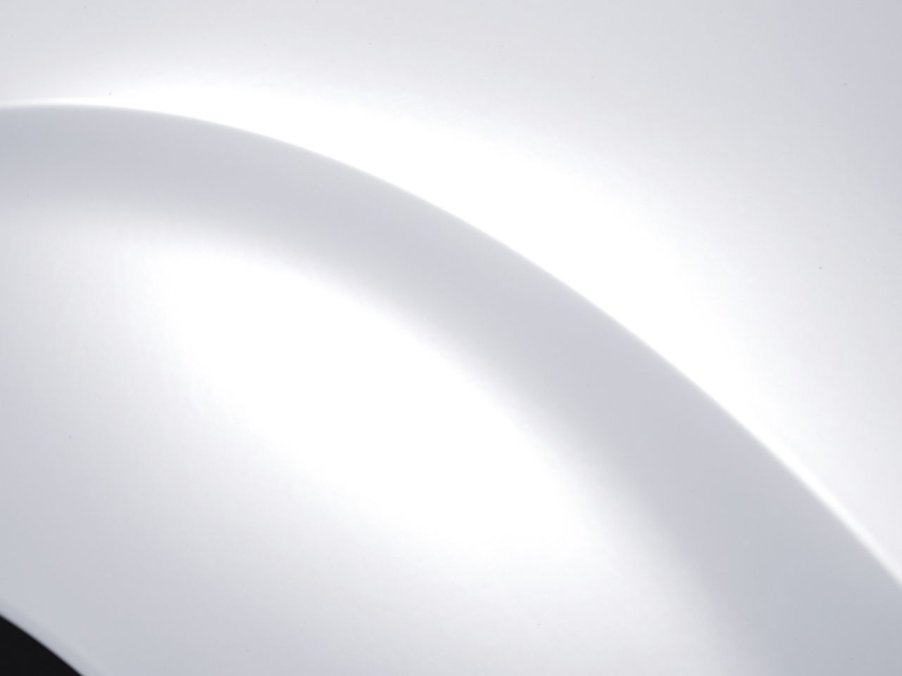 A close up of a white curve on a white surface.