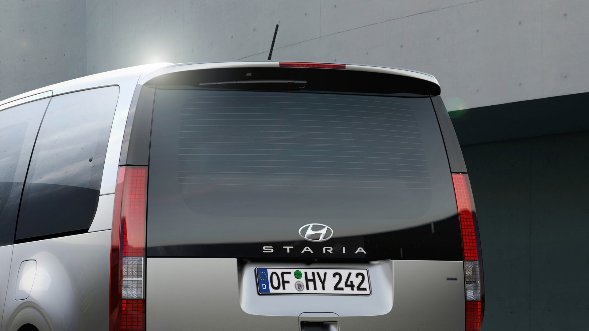 A silver hyundai van with license plate of hy 242 Staria