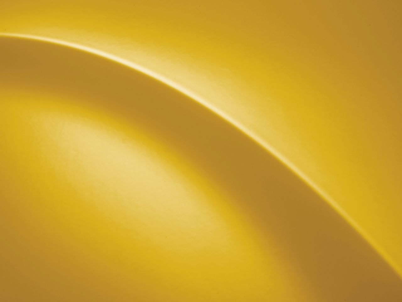 A close up of a yellow background with a curve in the middle.