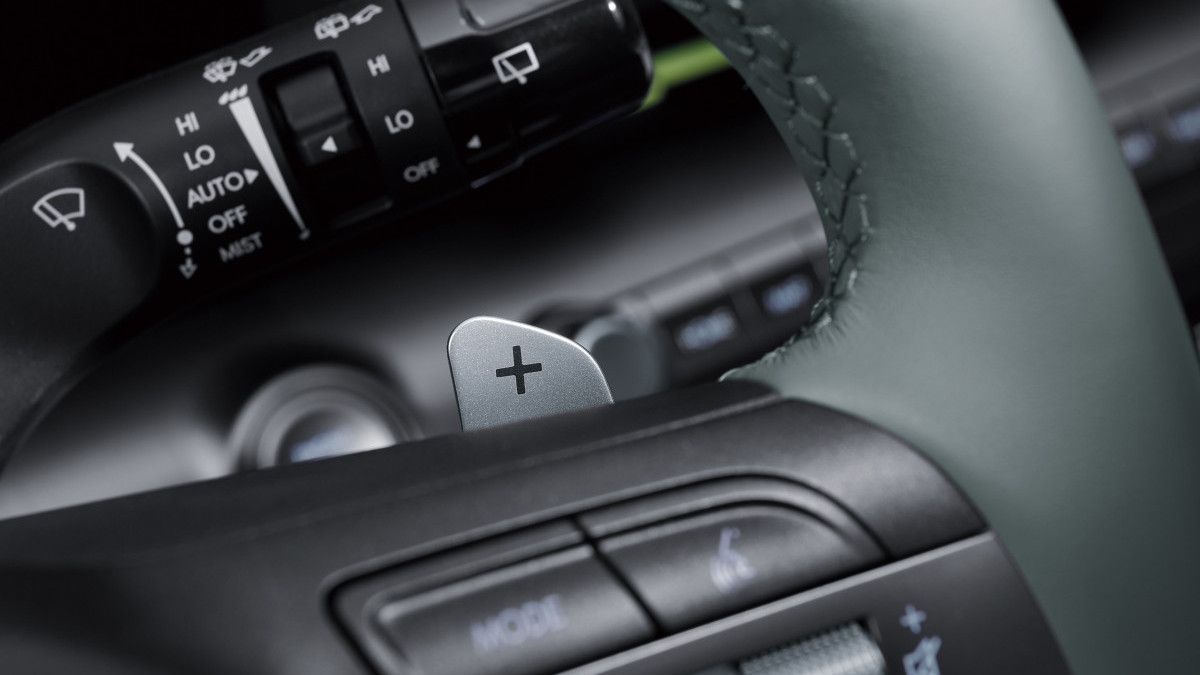 A close up of a car steering wheel and controls Kona