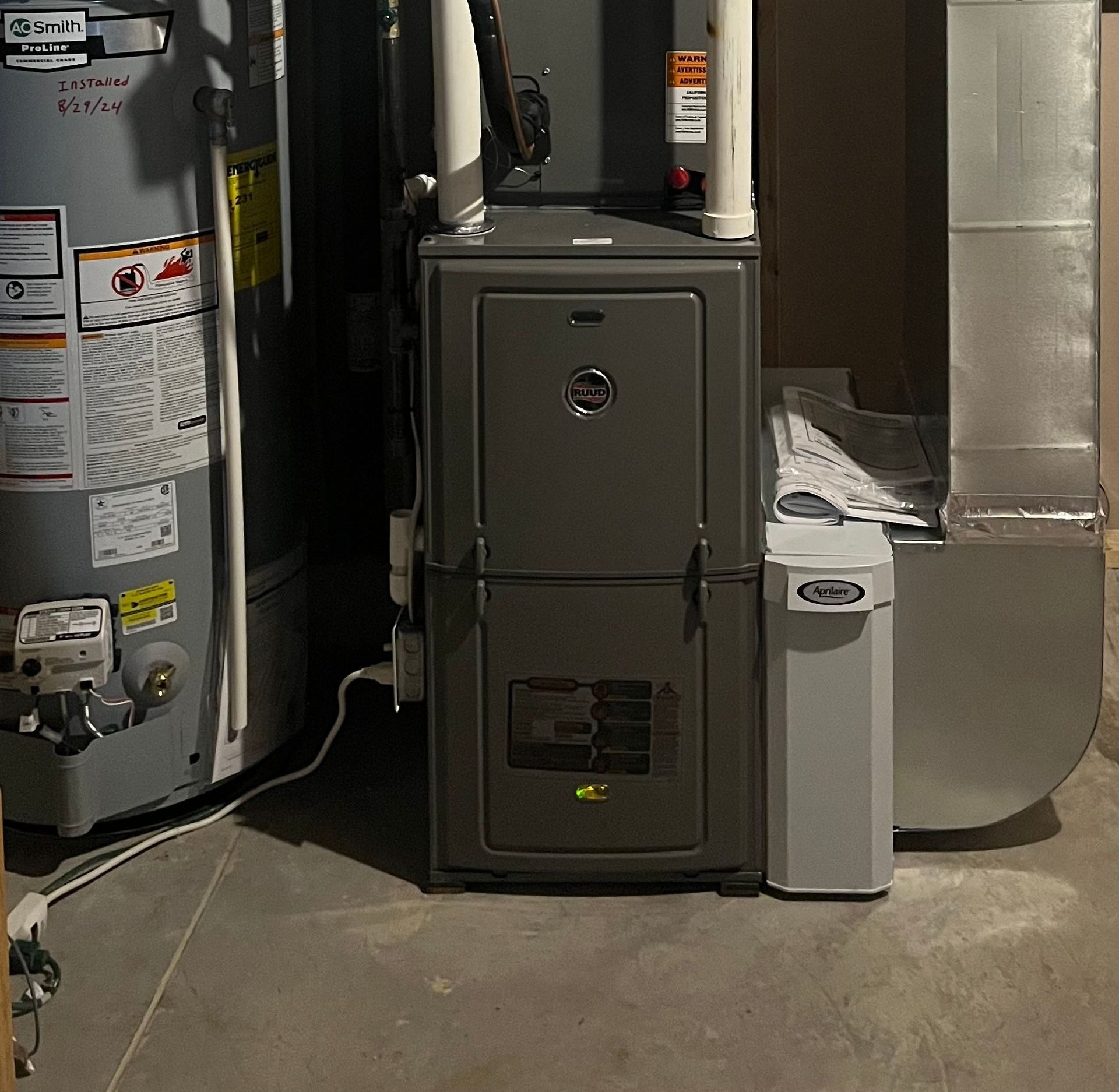 A mitsubishi air conditioner is sitting outside of a house.