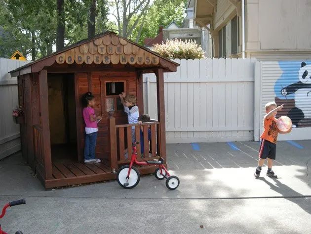 Children Playing in Wooden Playhouse — Sacramento, CA — Tot Town Child Development Center, Inc.