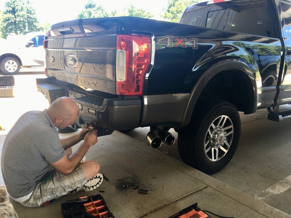 Man Working on Car Trunk