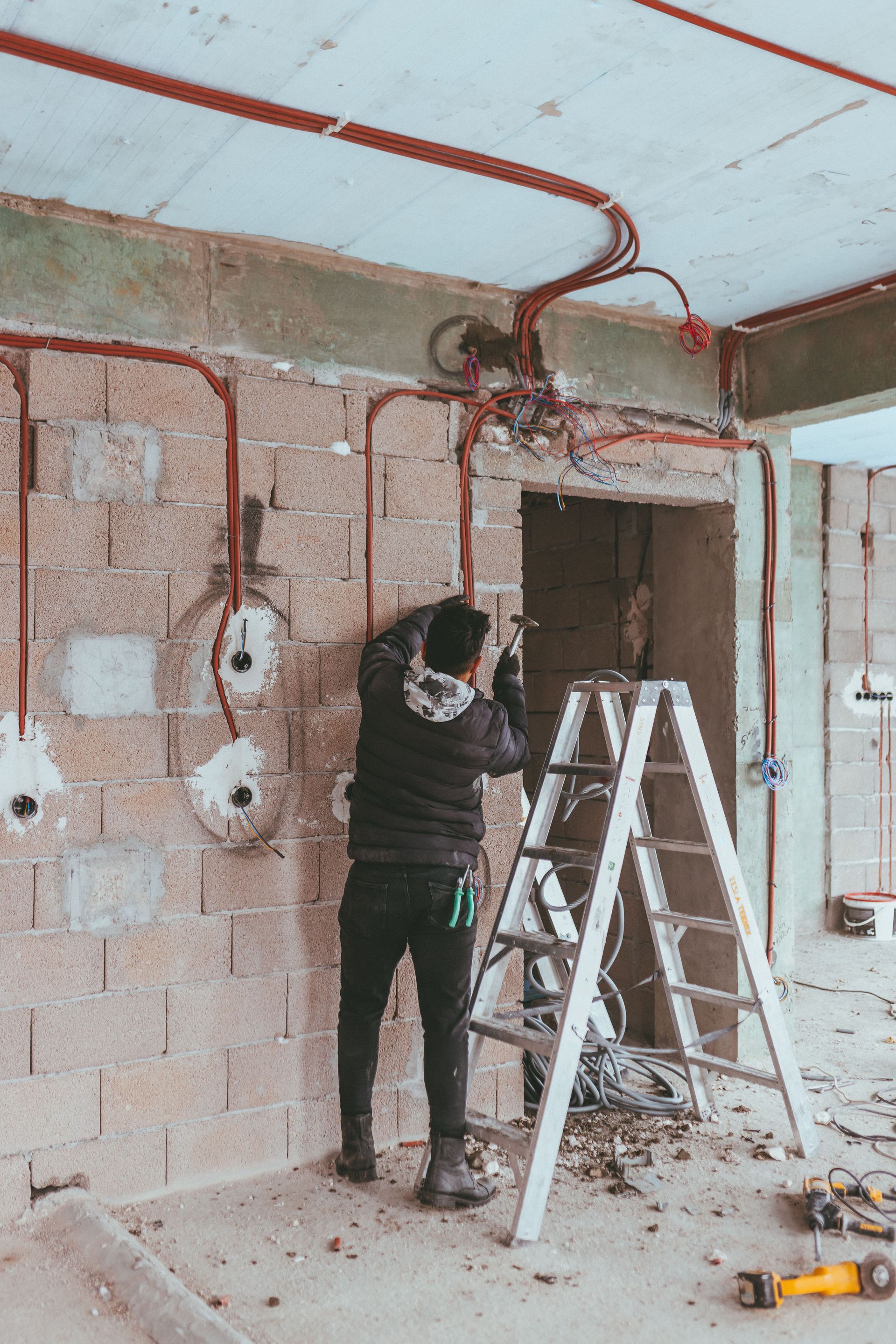New construction electrician installing wiring in a new home in West Virginia