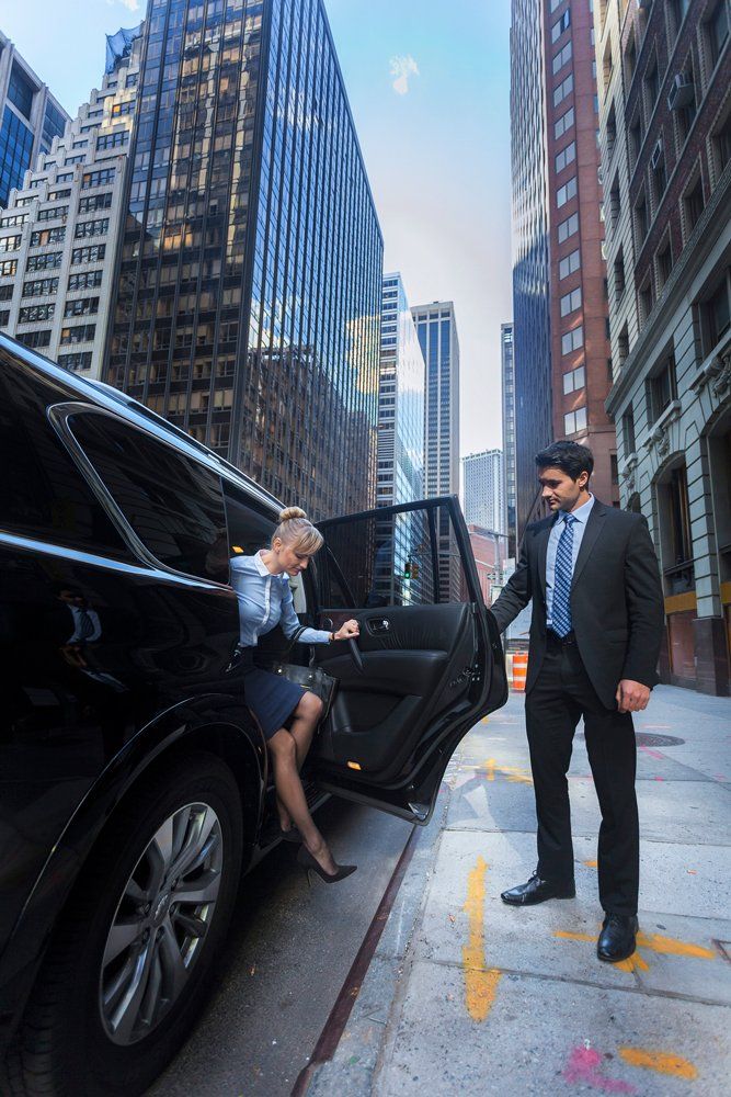 Opening Car Door For A Woman — Kalamazoo, MI — Five Star Rides, LLC Opening Car Door For A Woman — Kalamazoo, MI — Five Star Rides, LLC