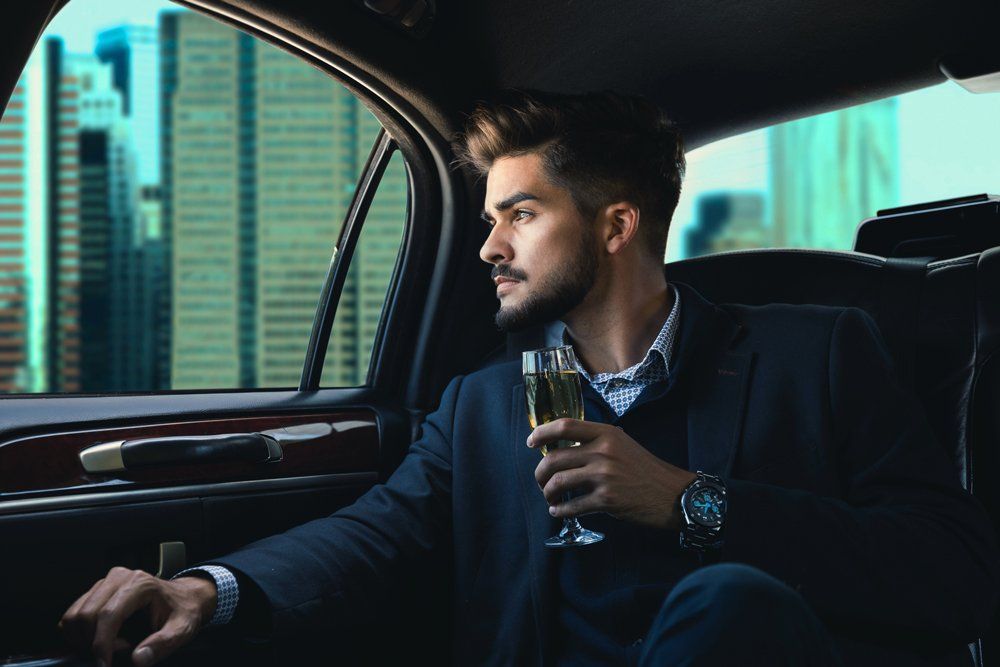 Man Inside A Limousine — Kalamazoo, MI — Five Star Rides, LLC Man Inside A Limousine — Kalamazoo, MI — Five Star Rides, LLC